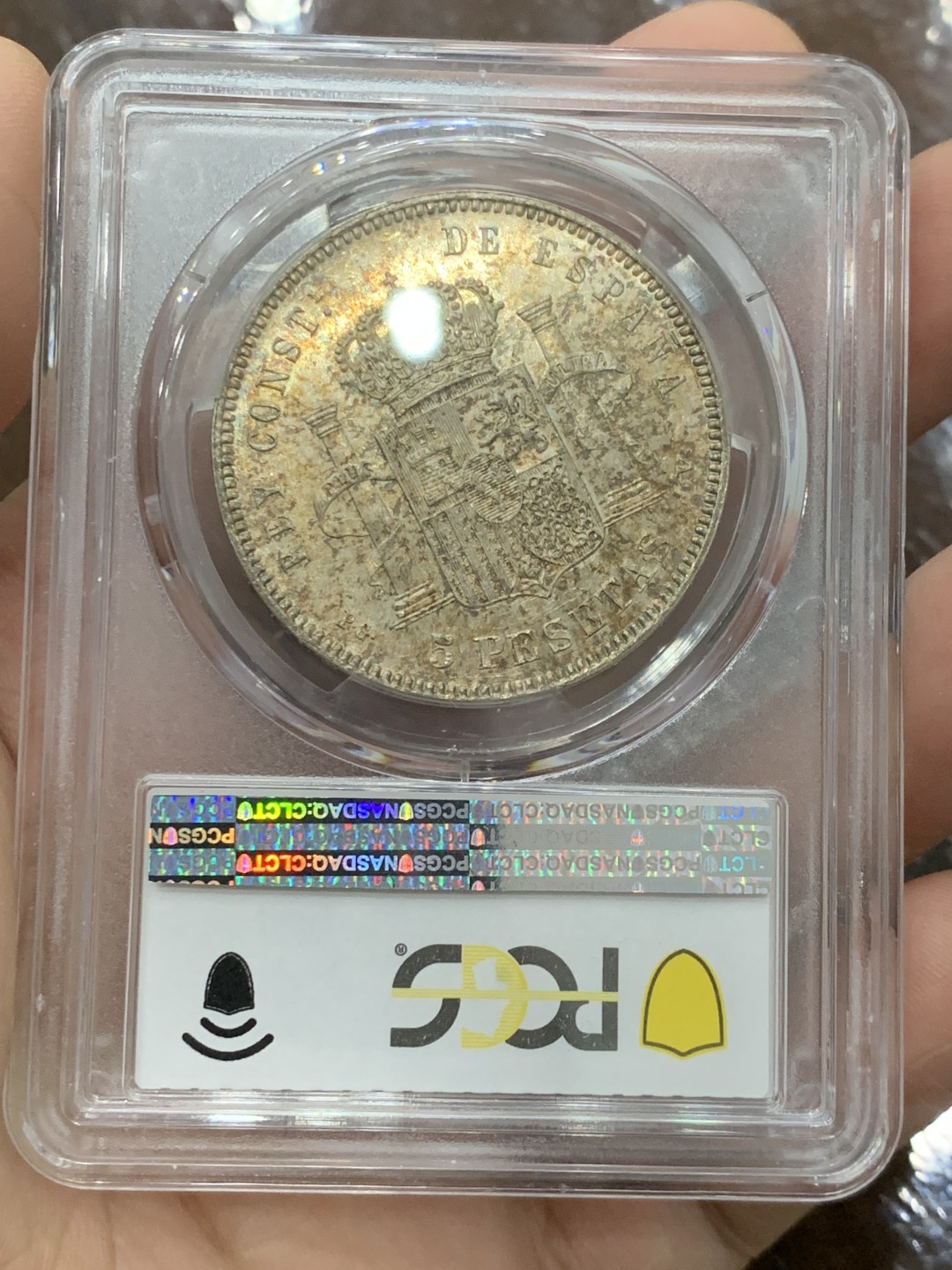 欢迎参加《竞宝斋》五一特拍-第161场-周日，周一 2场 唯一冠军分 PCGS-MS63 西班牙1893年 阿方索十三世 5比塞塔双柱大银币 五彩包浆 此版PGV比PGL稀少两个级别 罕见品种