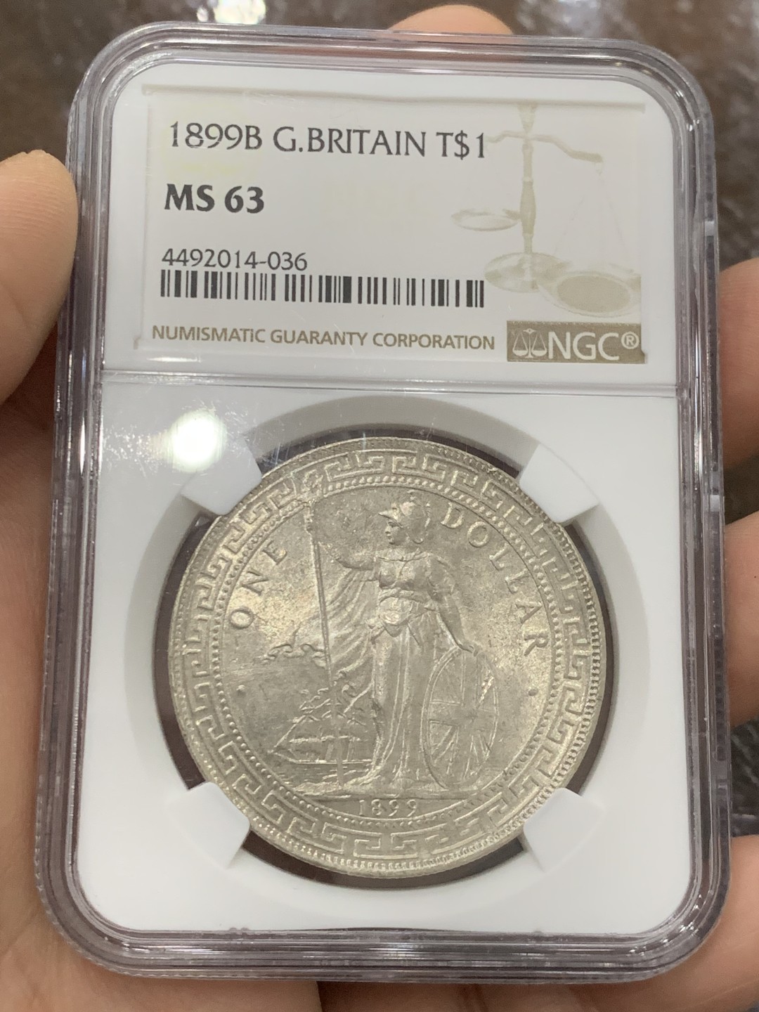 欢迎参加《竞宝斋》五一特拍-第161场-周日，周一 2场 NGC-MS63 英国1899年站洋1元银币，早期年份好品，银霜转光品相