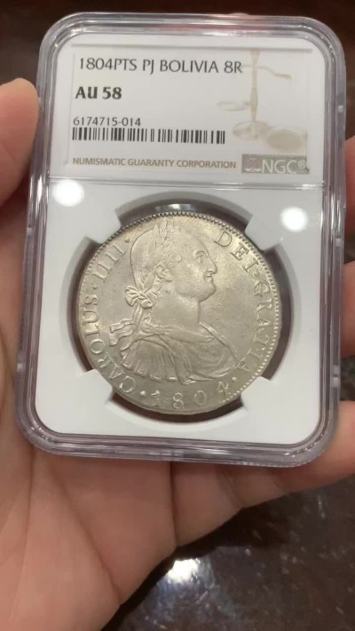 欢迎参加《竞宝斋》五一特拍-第161场-周日，周一 2场 NGC-AU58 西属玻利维亚 1804年卡四8R银币,高点俱全，底板几近无痕，铸纹还在，严重低评的一颗卡四