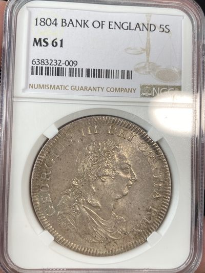 万国钱币拍卖第011期（视频直播专场） - NGC MS61 1804英格兰银行乔治三世5先令大银，加盖在西班牙双柱上的品种，原光淡包浆，状态舒服。