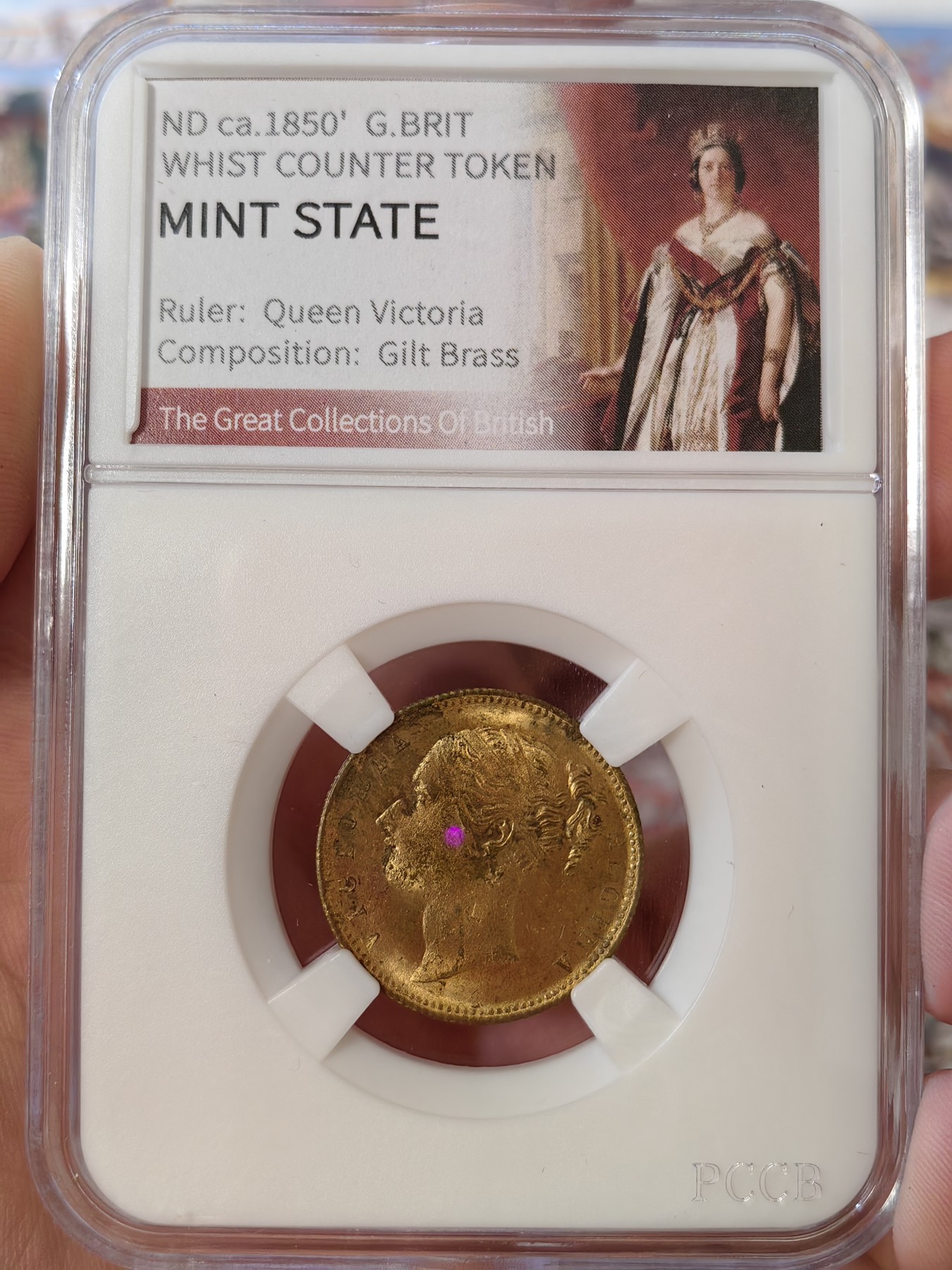 橡树集藏-006场 海纳百川 约1850年 英国 维多利亚女王 惠斯特牌代用币，在牌局中充当计数工具。尺寸参考了索维林的22mm，表面镀金，视觉效果和金镑无二，且少见的出厂状态，工艺比那些汉诺威的token要好上许多许多，雕刻技艺亦可圈可点，亚克力盒为开放式