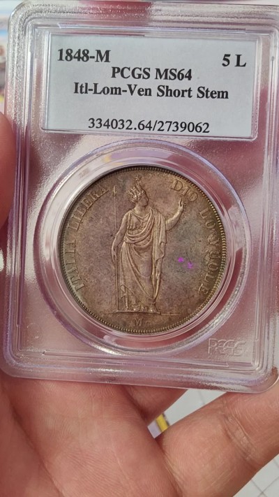 橡树集藏-006场 海纳百川 PCGS MS-64  1848年意大利伦巴第-威尼斯5里拉大银，米兰造币厂。钢灰色的底板呈现出琥珀色和浅洋红色虹彩的痕迹，突出了整个币面。背面有罕见的包浆回声纹，底板几乎没有瑕疵。pc老盒子，品质保证。正面是右手执长矛权杖的加冕自由女神，拉丁铭文:ITALIA LIBERA DIO LO VUOLE，上帝呼唤自由之意大利。女神的左手指向铭文“DIO”,意大利语中上帝的意思，很有深意的经典设计。 