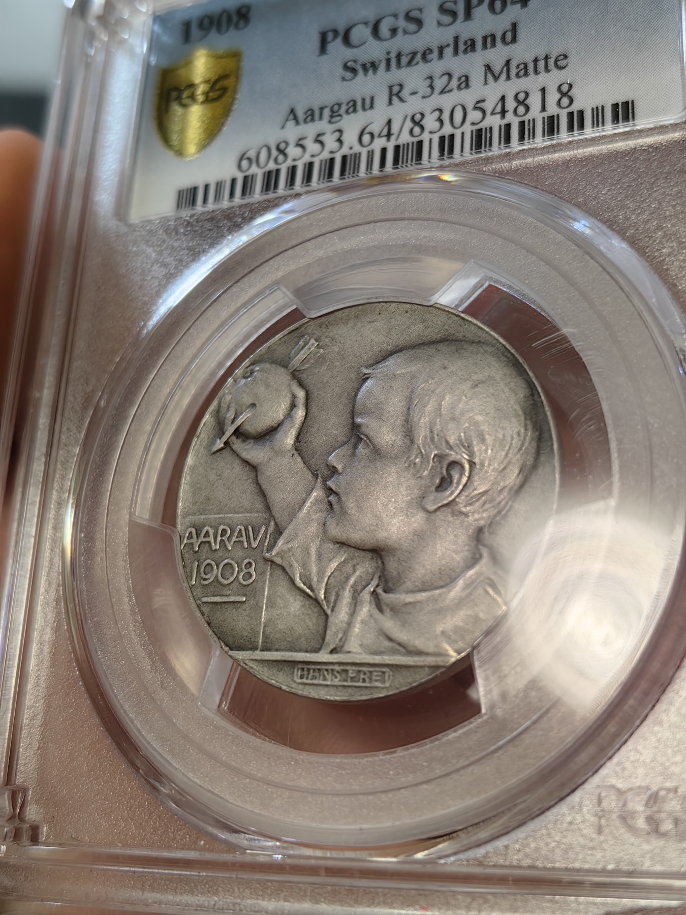 橡树集藏-006场 海纳百川 PCGS-sp64 1908年瑞士阿尔高州阿劳射击节 正面：风格化的鹰面向左，右爪握着阿尔高之盾；背面：威廉泰尔的小儿子，面向左侧，高举着被箭刺穿的苹果。新兴现代主义风格的迷人奖章。在里克特书中被列为“稀有”。铸造量仅293枚。