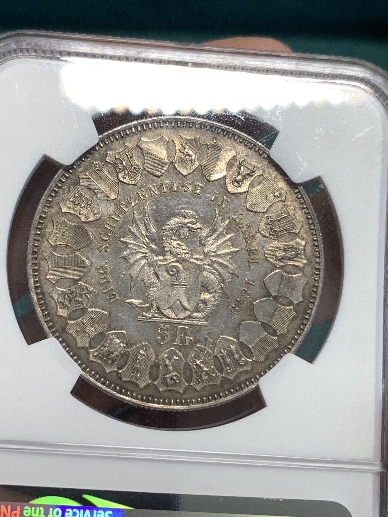 《竞宝斋》第187场-周日，周一 2场 (全场包邮) NGC-UNC 瑞士1879年 巴塞尔射击节5法郎银币   淡彩包浆 细节清晰