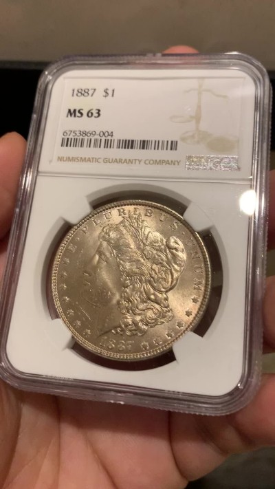 《竞宝斋》第198场-周日，周一 2场 (全场包邮) NGC-MS63 美国 1887年 摩根银币1美元 淡紫色包浆 转光感强烈