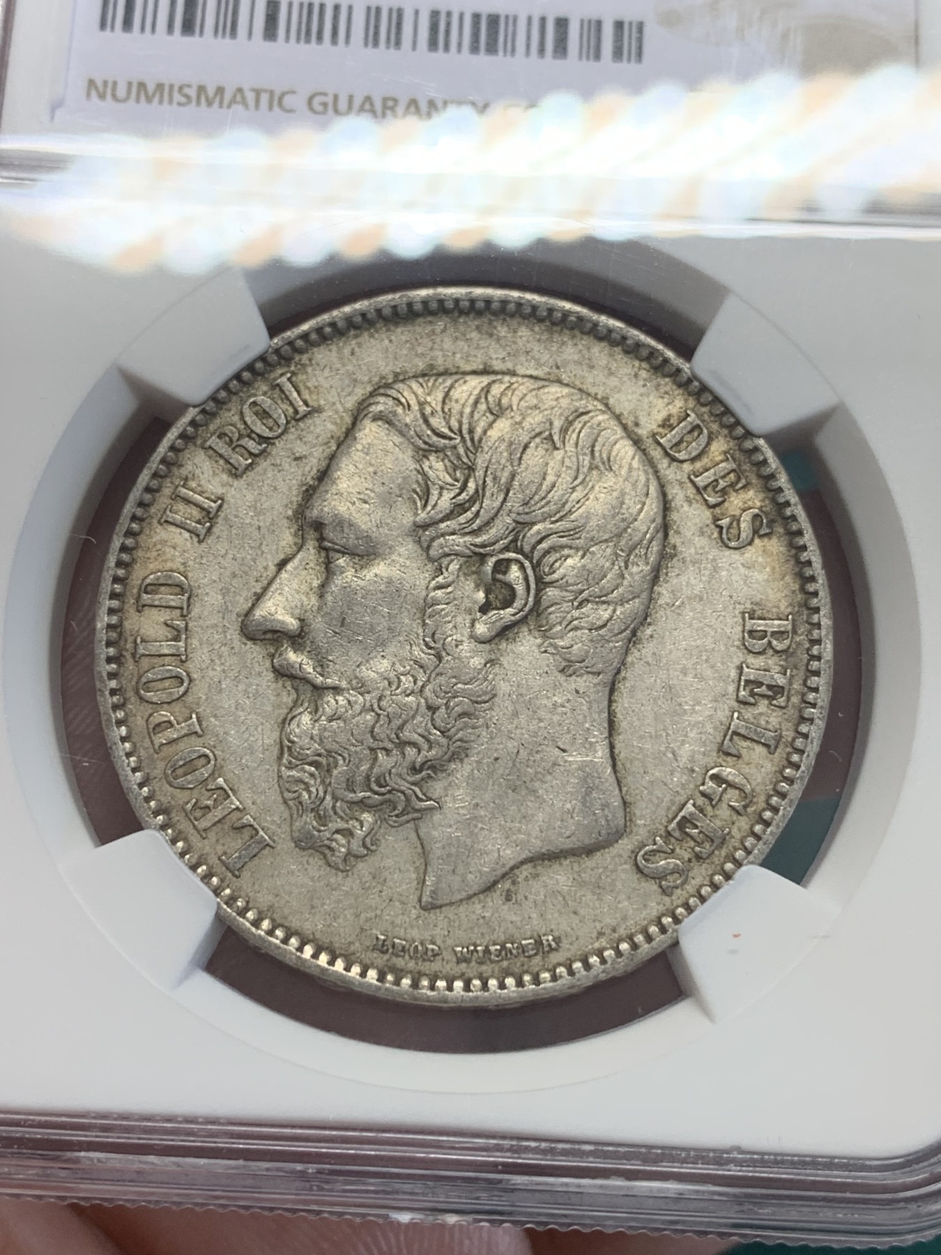 欢迎参加《竞宝斋》为国而庆 老张自藏专场 ，定制纪念章相赠 NGC AU 比利时1873年 利奥波德二世 5法郎银币 原味包浆 胡子清晰