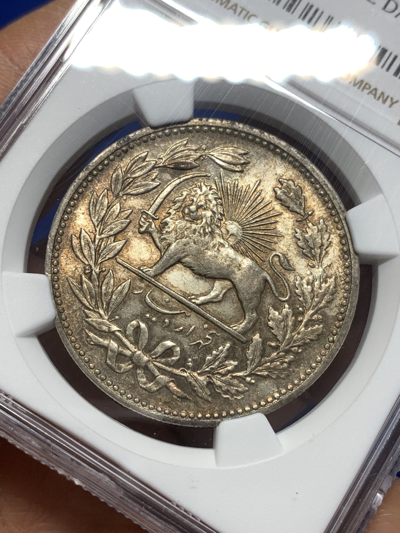 《竞宝斋》第215场-周日，周一 2场 (全场包邮) NGC AUD 1902伊朗5000第纳尔大银币，奶油黄，拿刀雄狮背后太阳清晰，包浆漂亮，整体感觉干净。