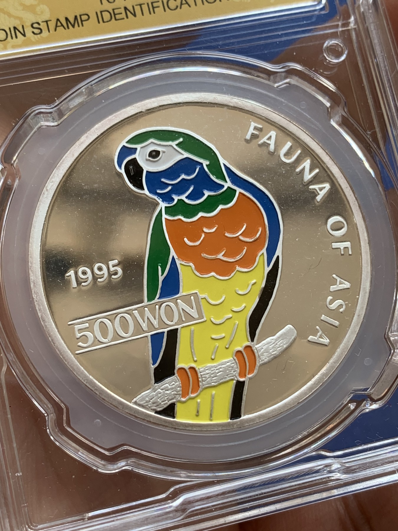 《竞宝斋》第215场-周日，周一 2场 (全场包邮) CSIS国评 PF70UC 1995年朝鲜中央造币厂发行国徽版鹦鹉1OZ彩色银币，31g 999银 完美品质，大热品种！