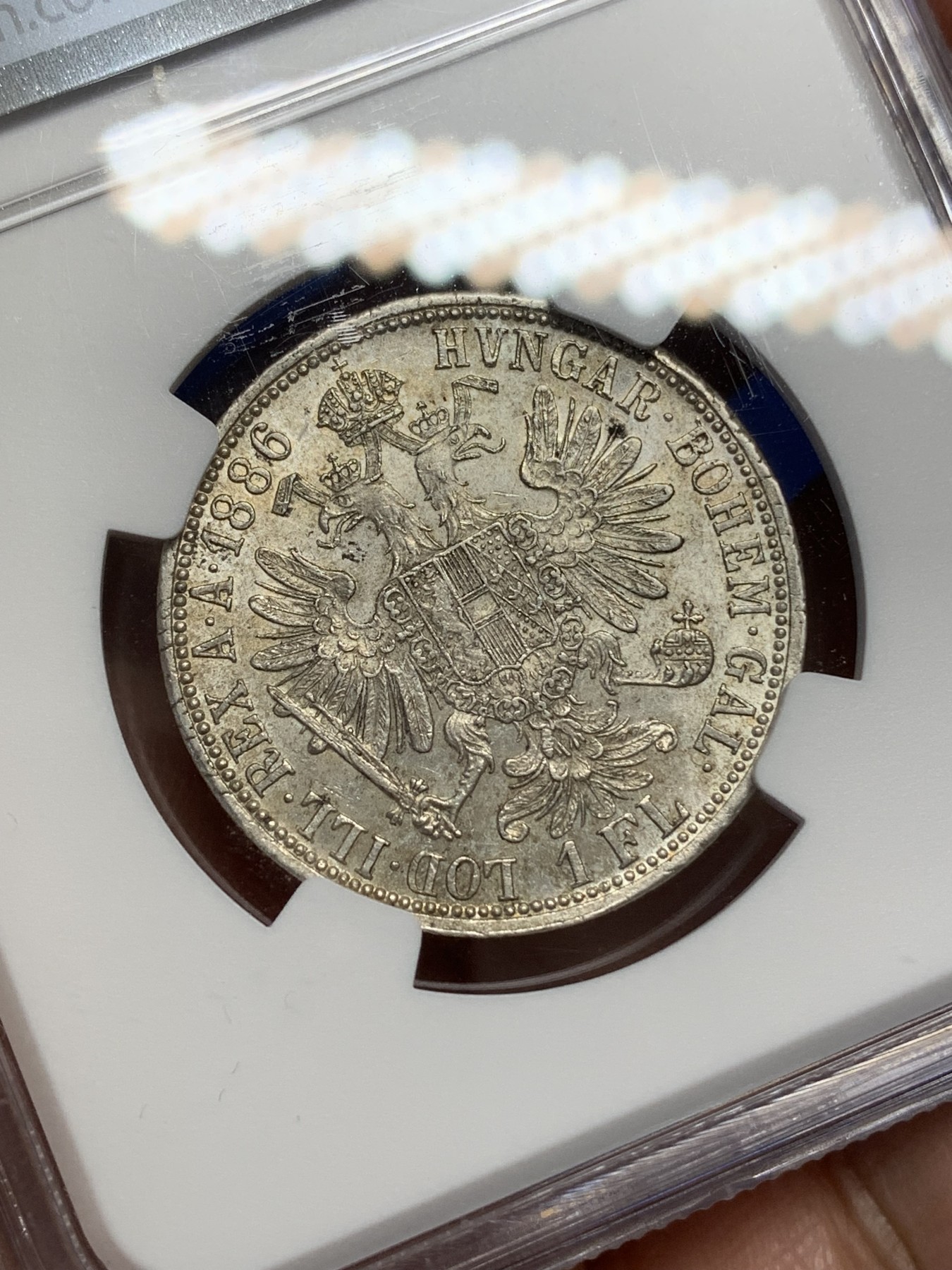 《竞宝斋》第216场-周日，周一 2场 (全场包邮) NGC-MS63 1886年奥匈帝国1弗罗林银币，弗朗兹约瑟夫皇帝像+双头鹰。底板丝滑，银光流畅。