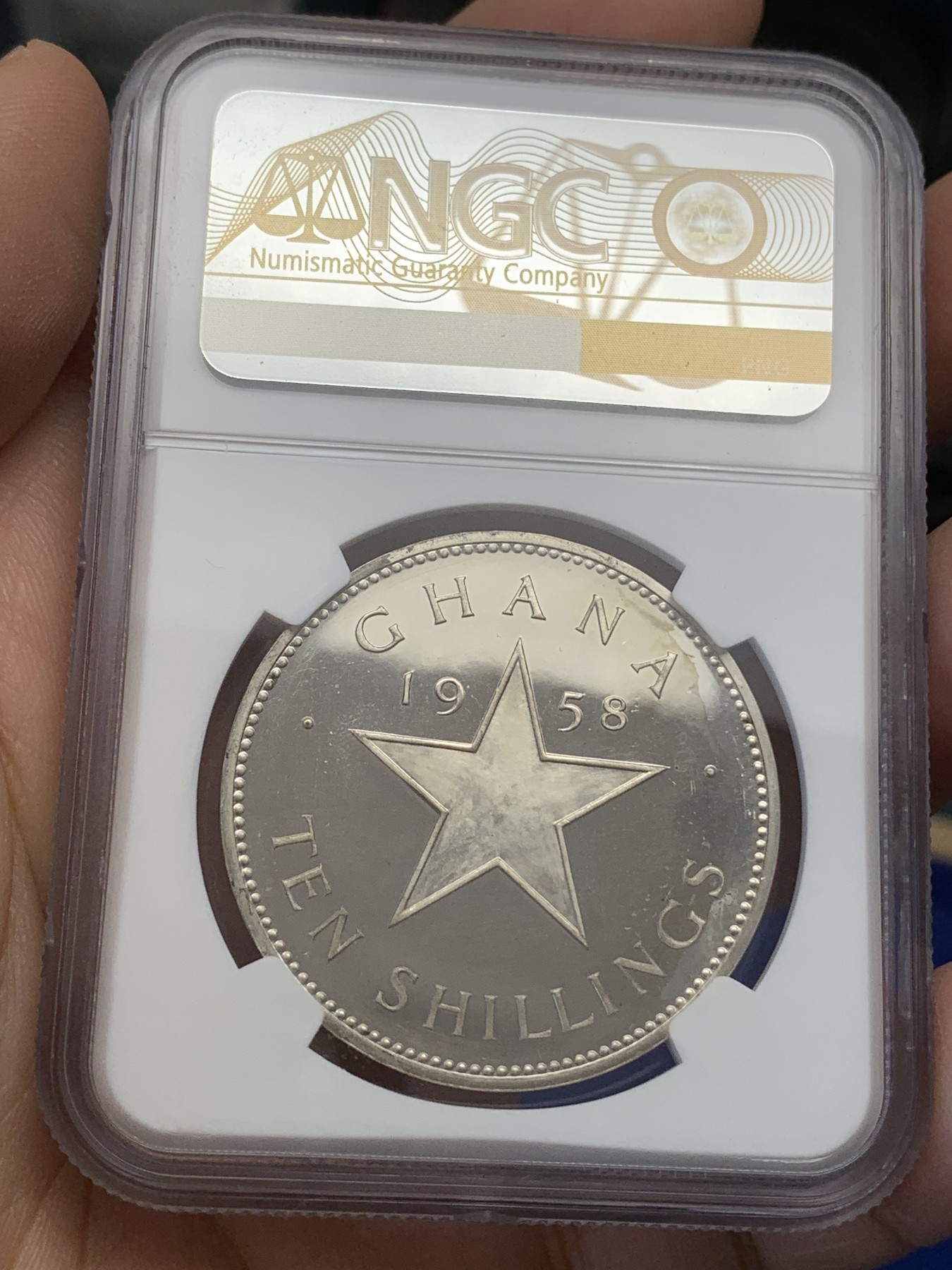《竞宝斋》第218场-周日，周一 2场 (全场包邮) NGC-PF65 1958年加纳独立10先令大五星精制纪念银币，直径38mm，重28.28克，925银，发行量32691枚。镜面状态精制币，状态极佳，获得更高评分的数目6枚。
