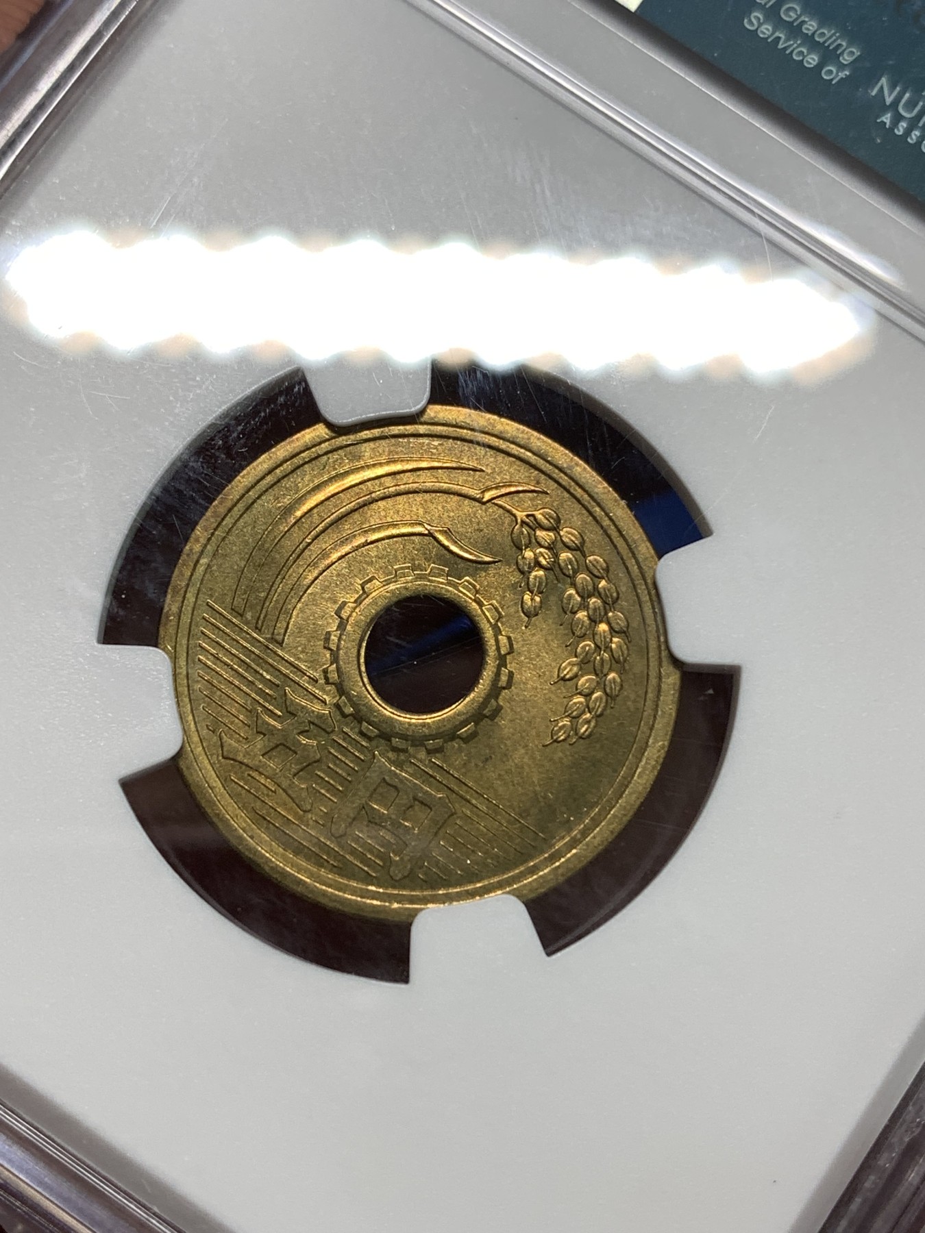 《竞宝斋》第218场-周日，周一 2场 (全场包邮) NGC-MS64 日本黄铜中孔繁体国最早一版五日元，楷书体版，昭和三十二年特年，MS64分N盒亚军分！少见的特年品种书上价格高（发行量仅100万）。喜欢的朋友不要错过了