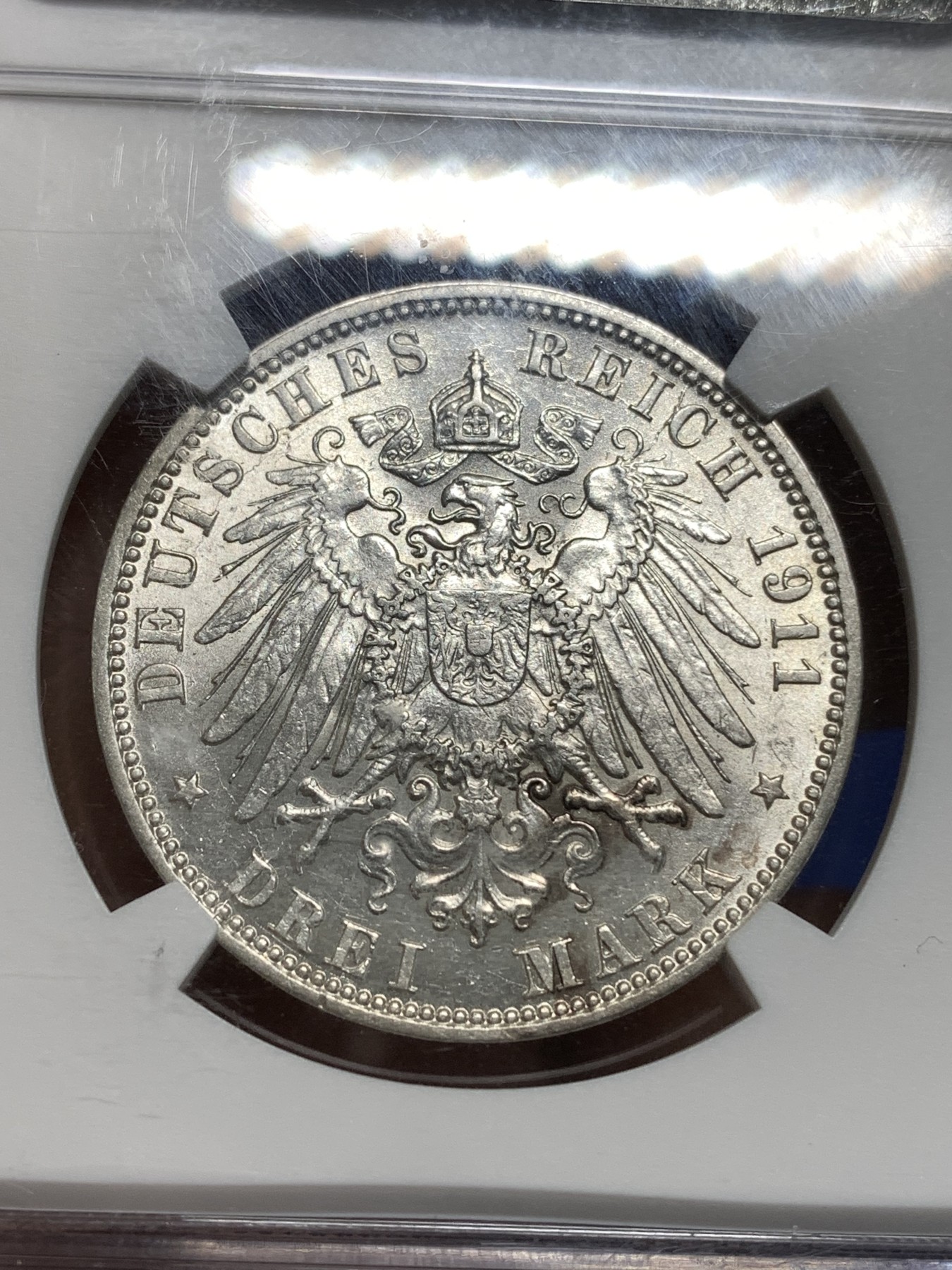 《竞宝斋》第221场-周日，周一 2场 (全场包邮) NGC-AU58 德国1911年汉堡自由市3马克银币，图案精美，纹饰优雅，历史价值浓郁。原汁原味老包浆，低评，状态绝对不输MS品质，非常漂亮，AU58超高的性价比，获得更高评分数量才95枚。