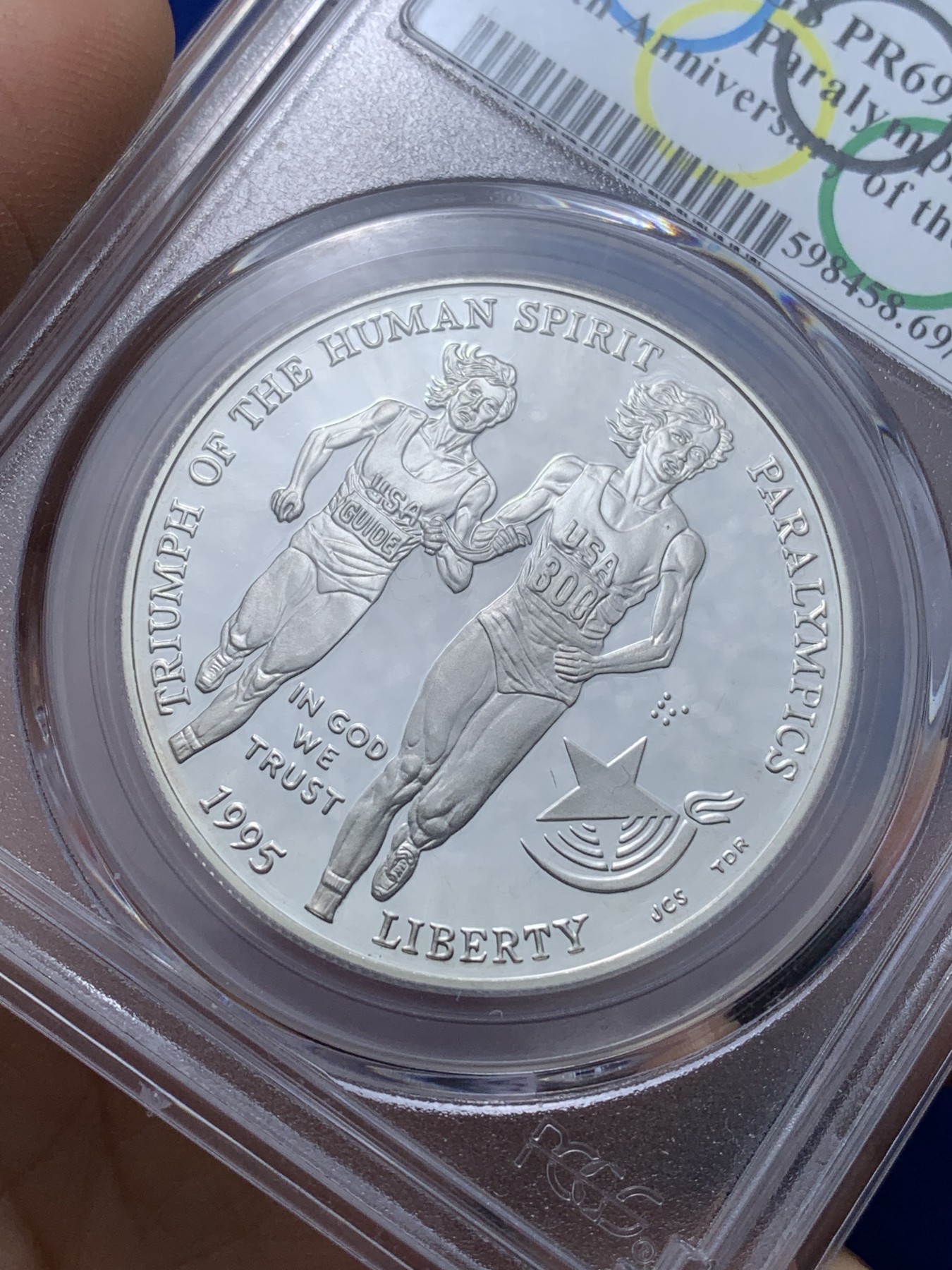 《竞宝斋》第221场-周日，周一 2场 (全场包邮) PCGS-PR69 美国1995年残奥会1美元精制纪念银币 ，PROOF全新镜面状态精制币，状态极佳，更高评级数量才25枚。