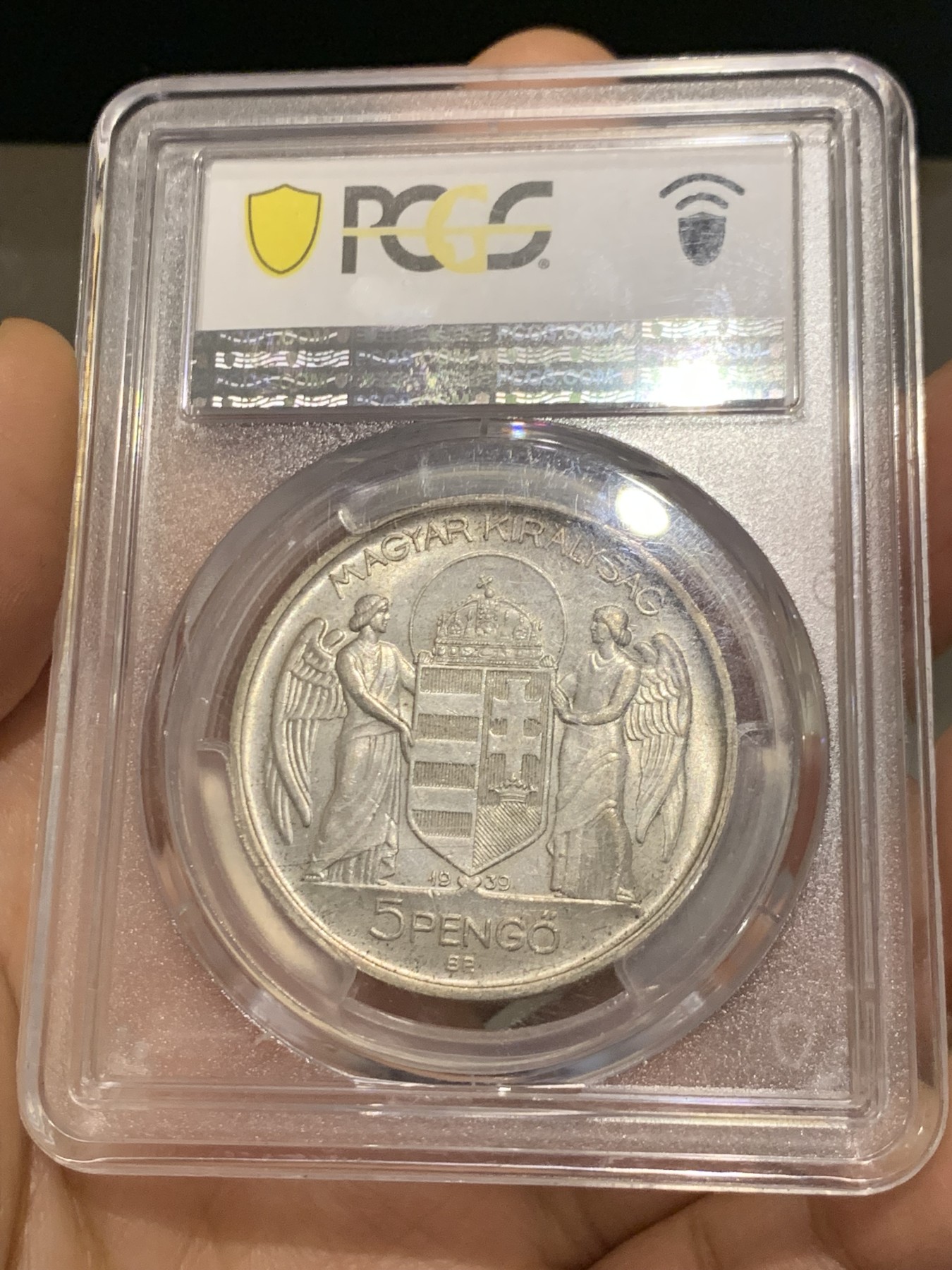 《竞宝斋》第223场-周日，周一 2场 (全场包邮) PCGS-MS65 匈牙利1939年海军上将霍尔蒂5潘戈银币，原厂初铸，难得高分。此枚银币人物神态刻画炯炯有神，清晰精美的戎装和背面的匈牙利盾徽天使制作精良，更高评级数量才6枚。