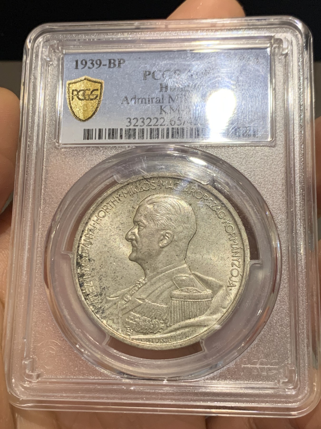 《竞宝斋》第223场-周日，周一 2场 (全场包邮) PCGS-MS65 匈牙利1939年海军上将霍尔蒂5潘戈银币，原厂初铸，难得高分。此枚银币人物神态刻画炯炯有神，清晰精美的戎装和背面的匈牙利盾徽天使制作精良，更高评级数量才6枚。