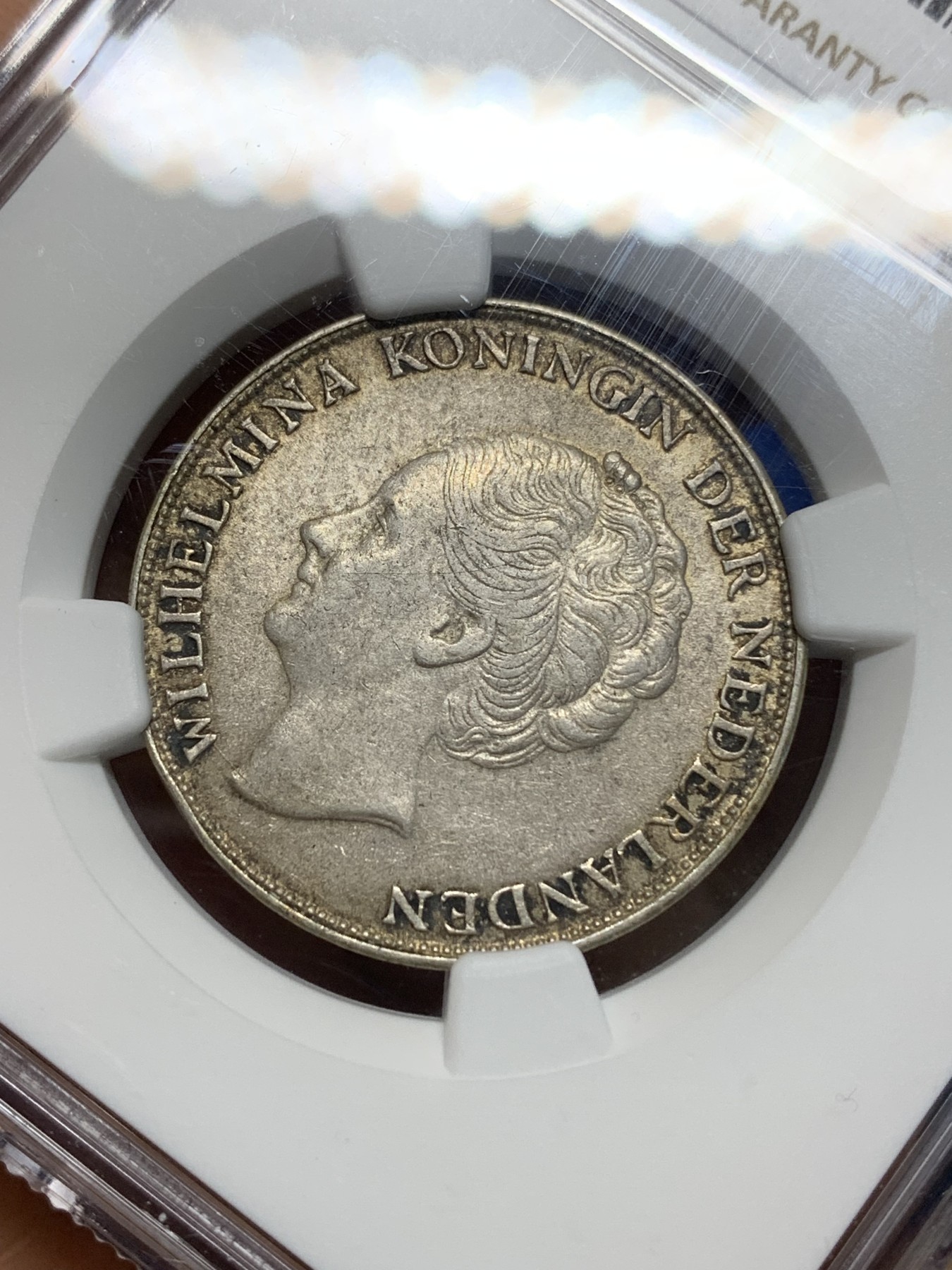 《竞宝斋》第224场-周日，周一，周二 3场 (全场包邮) NGC-AU58 荷兰流亡政府1944年威廉明娜女王1盾银币P版，不是普通的1盾。温润老包浆，58里的顶级状态