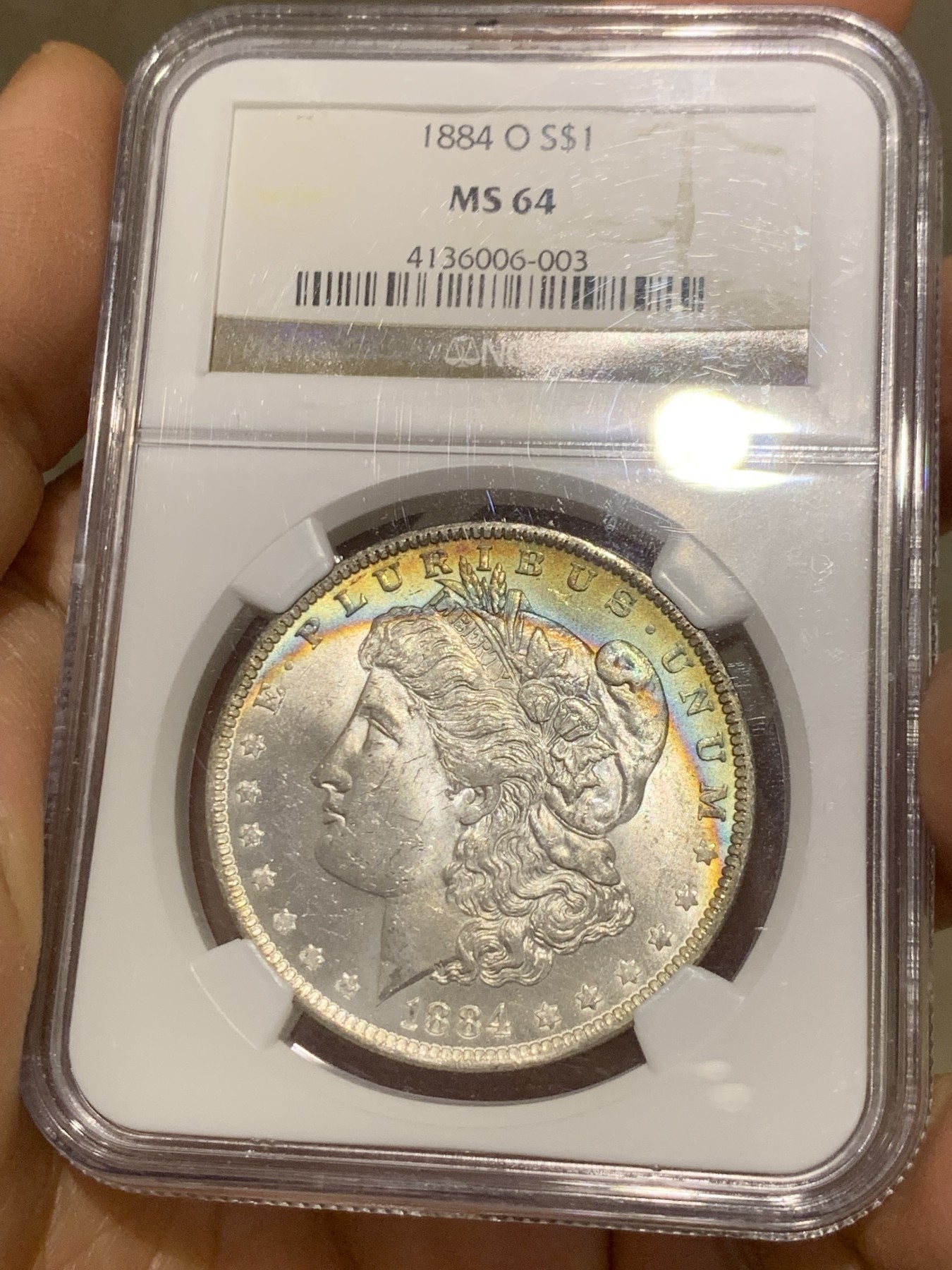 《竞宝斋》圣诞专辑  第二场  第228场 定制纪念章相赠 (全场顺丰包邮) NGC老盒评级MS64分。1884年O版摩根银元，月牙彩，彩虹包浆，好看包浆的摩根相比普通摩根海外溢价很高。今年汇率上涨，摩根是抗通胀好品种，64好彩勿错过。