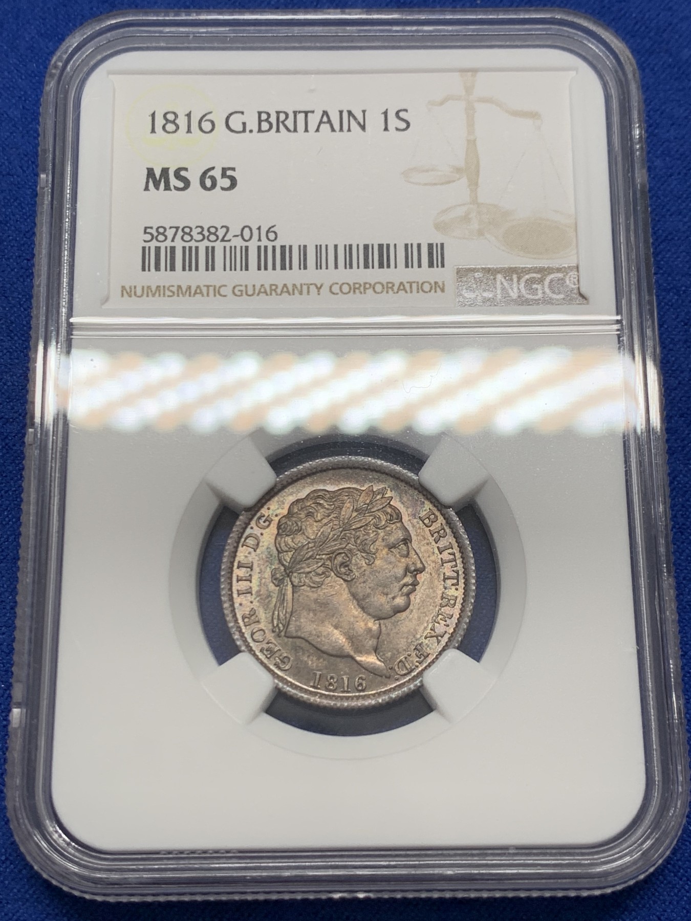 《竞宝斋》圣诞专辑  第二场  第228场 定制纪念章相赠 (全场顺丰包邮) NGC-MS65 英国1816年乔治三世 牛头1先令 银币。来自皮斯特鲁奇的经典设计，状态很舒服，分数够玩了。