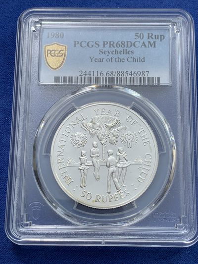 《竞宝斋》第239场-周日，周一 年终拍场 (全场包邮) PCGS-PR68 塞舌尔1980年国际儿童年50卢比精制纪念银币，925银，发行量1万枚。PROOF精制币，镜面状态，获得更高评级数量6枚。