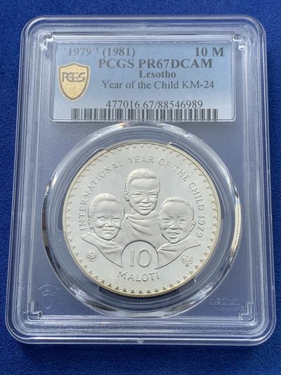 《竞宝斋》第239场-周日，周一 年终拍场 (全场包邮) PCGS-PR67 莱索托1979年国际儿童年10洛蒂精制纪念银币，直径40mm，重28.28g，925银，发行量37050枚。PROOF精制币，镜面状态，获得更高评级数量10枚。