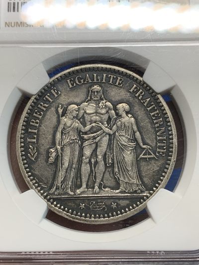 《竞宝斋》第239场-周日，周一 年终拍场 (全场包邮) NGC AU 法国1871A三叉戟公社大力神5法郎银币，细节全在，老包浆原味好品，Date espacée 罕见间隔年份小版别（7-1间隔更大），属于大力神系列名誉珍品，发行仅72天，于法国临时政府期间。A厂巴黎铸造，厂标三叉戟。好品轻松过万