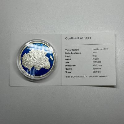 康怡轩钱币【安道尔+西班牙+拉脱维亚+刚果+瑞士+奥地利 纪念币专场】第251014期 2010年科特迪瓦发行希望大陆镶施华洛世奇水晶彩色纪念银币  有证无盒  1枚