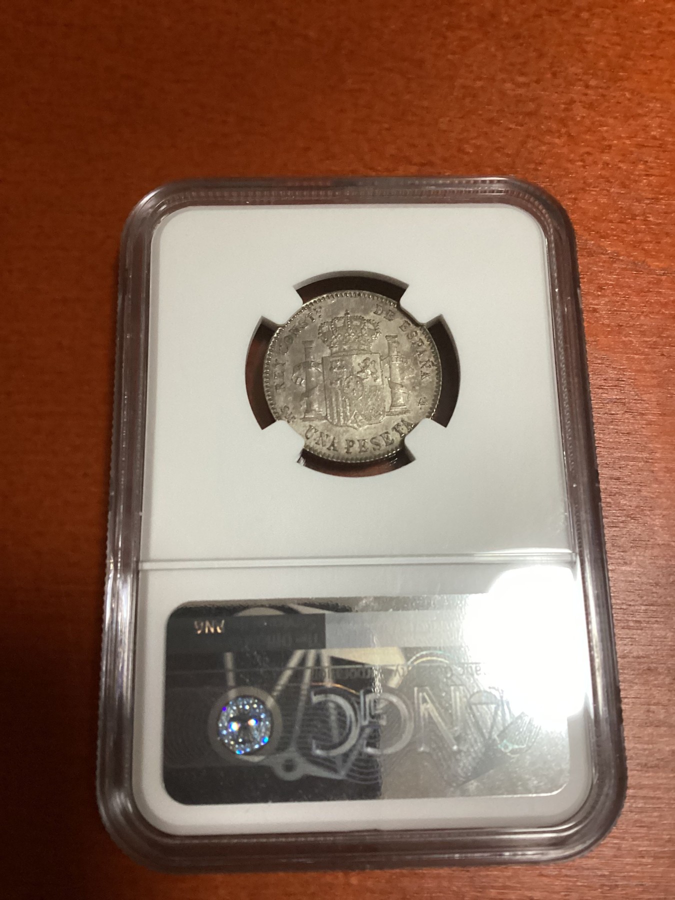 长老汇兔年精选第二场 1900(00) SMV 西班牙阿方索十三世1比塞塔银币，NGC MS61分，更高分仅有26枚，这个有分数的比8里亚尔大银币少多了