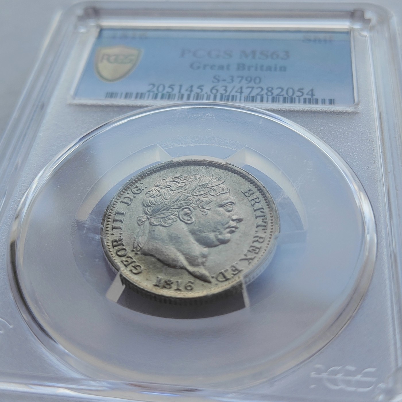 🏮💰物与斋新春连拍3-世界近现代硬币专场（共三场合并发货） PCGS-MS63 英国1816年乔治三世牛头先令银币，淡黄油彩，盒子正面略有磨损如图