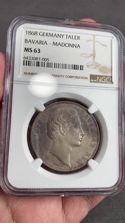 万国钱币拍卖第021期（龙年首拍） NGC MS63 1868年德国巴伐利亚纪年路德维希二世圣母抱婴流通1泰勒 犹抱琵琶半遮面式的美丽包浆让这枚泰勒增添了一丝神秘而又美丽的面纱