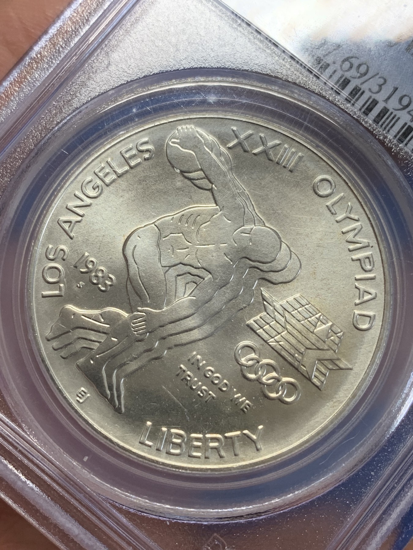 《竞宝斋》第245场-周日，周一 ，周二3场连拍 (全场包邮) PCGS-MS69 美国1983年S版洛杉矶奥运会掷铁饼/雄鹰1美元纪念银币，磨砂普制版，状态极佳，PC早期老盒严评无官网图，更高评级数量才67枚。