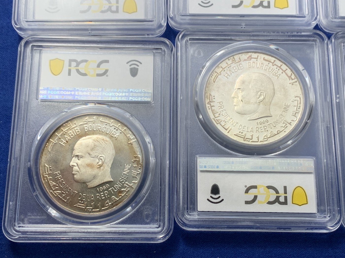 《竞宝斋》第246场-周日，周一 ，周二3场连拍 (全场包邮) 10枚一组 突尼斯1969年古代文明10枚精制大银币全套，国外运回国原样送评，8枚入盒，2枚pvc，整体五彩包浆比较厚，导致分数偏低，币面无明显擦痕，不想折腾了，感兴趣的可以养护下再送，有惊喜。