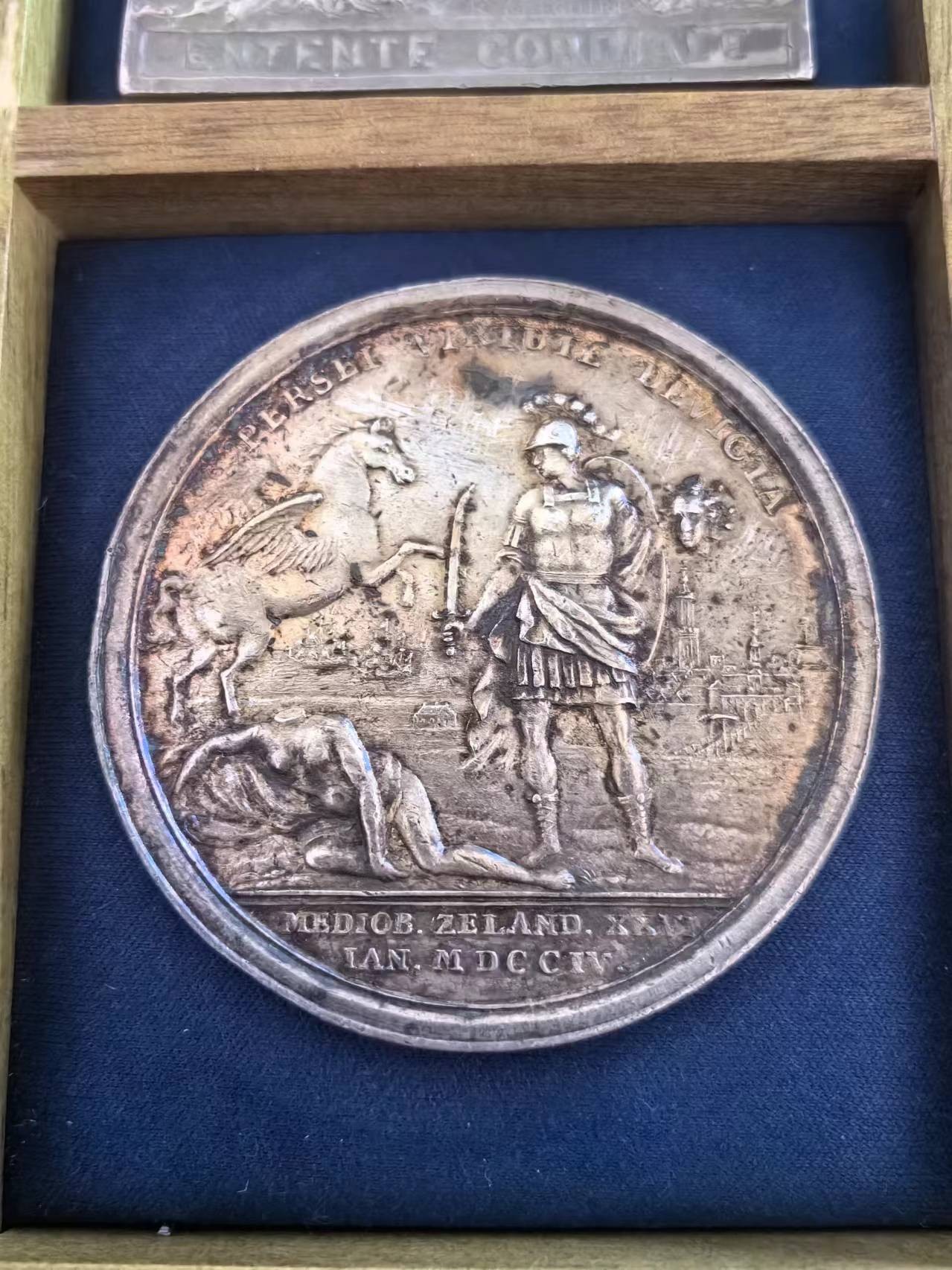 外国币章第二十二期（一分钟快速结束） 1704年荷兰银章，镇压西班牙王位继承战争（1701-1704）期间在米德尔堡市和泽兰省爆发的骚乱，49mm重47g。正面是珀尔修斯（希腊神话人物，英仙座）身穿古代盔甲，挥舞宝剑砍下美杜莎的头颅，飞马座向右跳过被斩首的美杜莎身体，背景中的米德尔堡观。背面由民兵保卫的米德尔堡市政厅；自由女神正面站立，将帽子放在旗杆上，手放在展开翅膀的雄鹰上，站在刻着S P Q M的塔楼上。