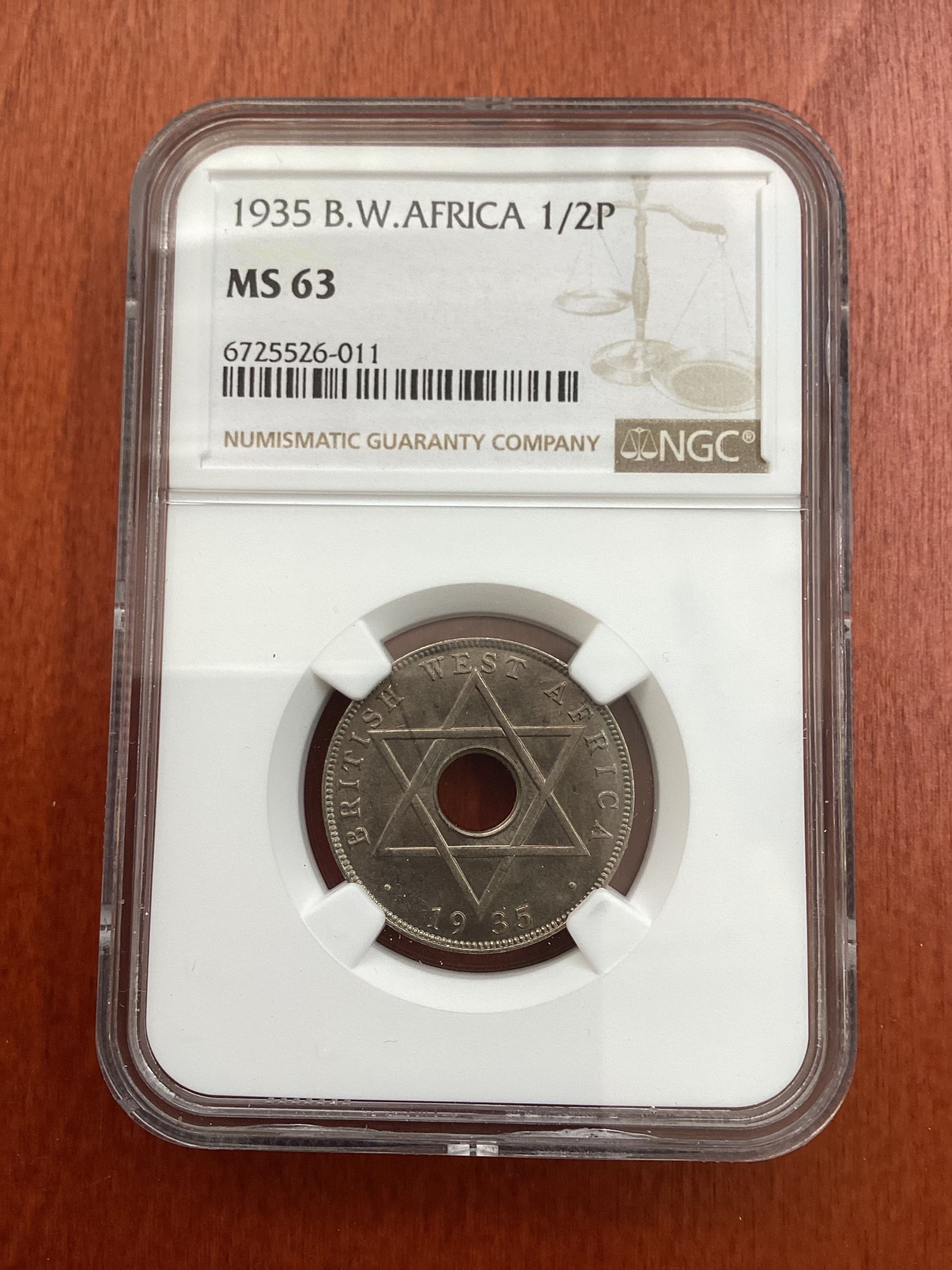 长老汇龙年精选第三场 1935 英属西非乔治五世1/2便士中孔铜镍币，NGC MS63分，更高分仅有5枚