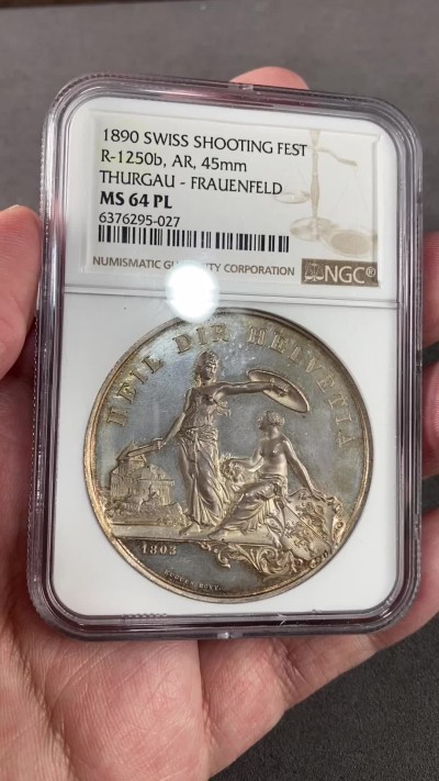 万国钱币拍卖第023期（金辉银韵之夜） NGC MS64PL 1890瑞士图尔高射击节大银章 完美的镜面，完美的包浆，一切都是那么恰到好处。