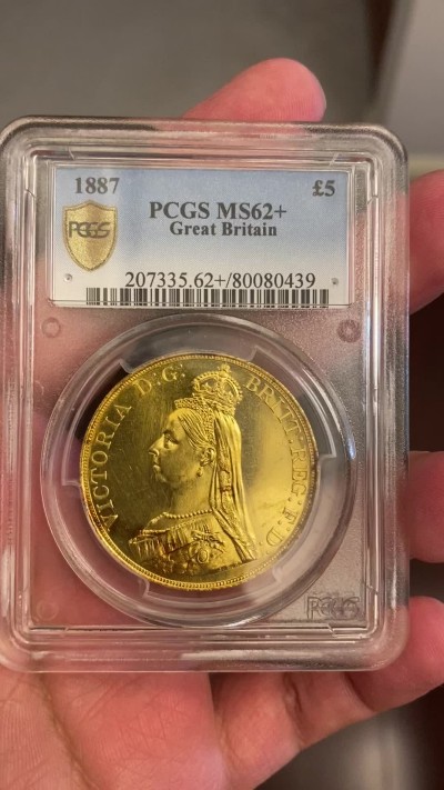 万国钱币拍卖第023期（金辉银韵之夜） PCGS MS62+ 1887英国维多利亚女王5镑金币 发行量54000枚，近40g的重量足以在流通金币当中傲视群雄，黄金的闪耀与经典的圣乔治屠龙完美结合，此枚打制深峻，底板类镜面质感，光泽强烈，在黄金暴涨的大环境下，堪称投资与收藏的双赢之选，再高半分的价格可能就是另一个档次的存在，此次入手机会切勿错过。