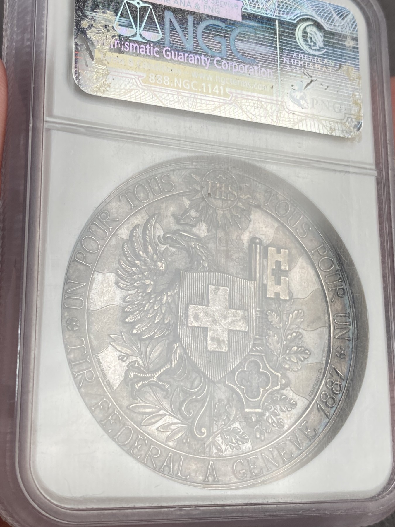万国钱币拍卖第023期（金辉银韵之夜） NGC MS64 1887瑞士日内瓦射击节大银章，超高浮雕，顶级品相。