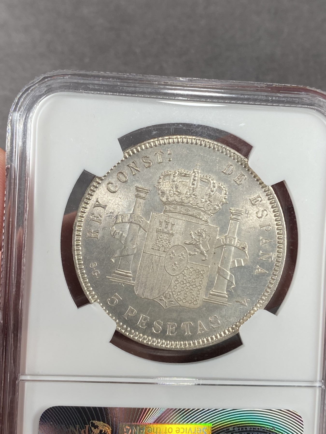 万国钱币拍卖第023期（金辉银韵之夜） NGC MS63 1899西班牙阿方索十三世5比塞塔 少年头像版本，无比丝滑的底板与转光，NGC老盒罕见品相。