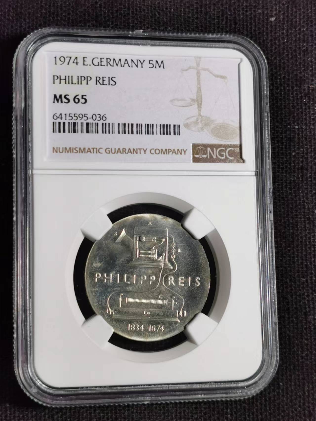 刘世昌艺术品销售中心～虎踞龙蟠*金杨在线联拍群第515期 民主德国1974年“菲利普.雷斯～雷斯单向电话发明者”逝世一百周年5马克纪念币（NGC MS65 串号：6415595-036）1枚。