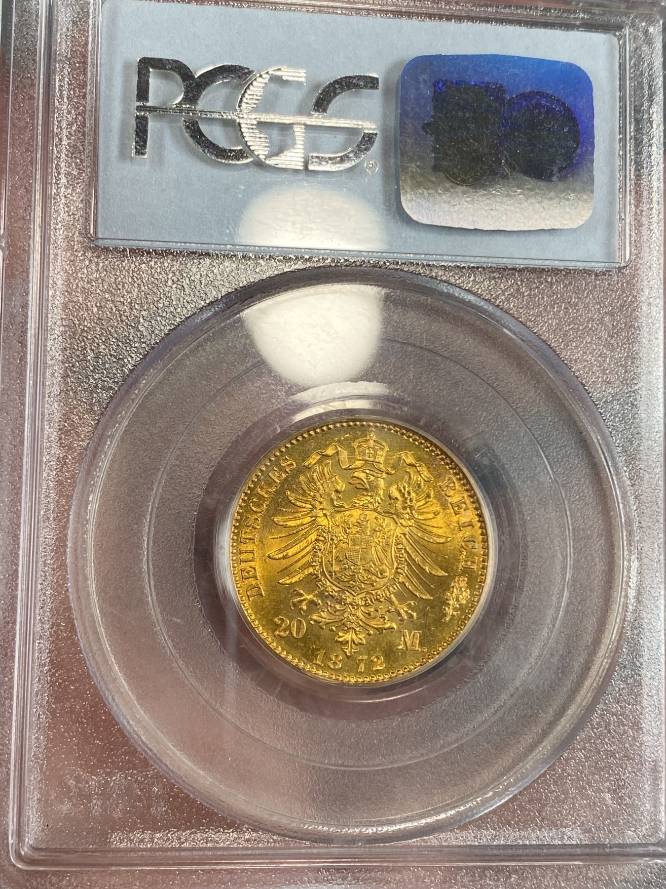 万国钱币拍卖第024期（诸神之战） PCGS MS63 1872年德国普鲁士威廉一世短翅20马克金币 经典品种配经典PC白盒，状态喜人，应该有得+，好品非常难得的短翅金马克，更高分仅9枚，7.96g，900金。