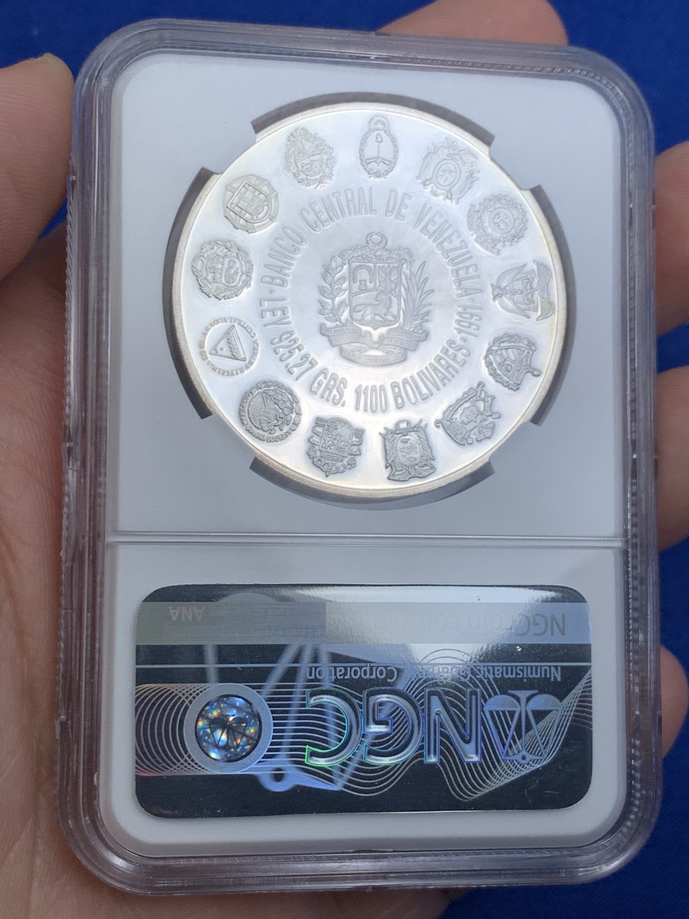 《竞宝斋》第263场-周日，周一 2场连拍 (全场包邮) NGC PF67UC 1991委内瑞拉1100玻利瓦尔银币，非常少见的委内瑞拉银币品种， 纪念哥伦布发现新大陆，正面是哥伦布全身像，背面是拉丁美洲各国国徽图案，委内瑞拉银币也是国际市场的热门品种，不容错过