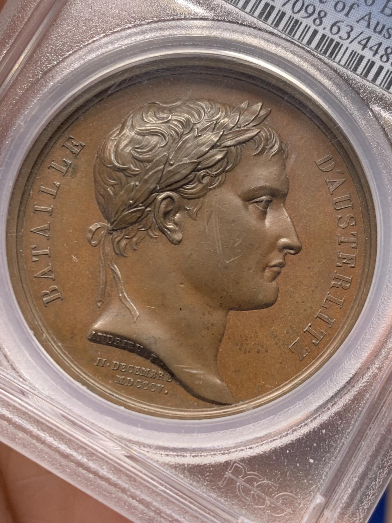 《竞宝斋》立夏专场特拍 （第2-1场）全场顺丰包邮 265场 PCGS SP63 法国1805年拿破仑一世原铸铜章 为纪念1805年拿破仑在奥斯特里茨战役（三皇会战）打败俄奥联军，Andrieu铸造了一枚简单粗暴的纪念章。在纪念章的背面，沙皇亚历山大一世与奥皇弗朗茨二世的头像拥挤在狭小的空间里，与正面雄伟的拿破仑肖像形成对比。这枚章有意思就有意思在设计者根本不按常理出牌：1、正面不刻皇帝称号 2、背面不做任何象征性修饰，不写任何描述性文字 3、直接把对面老大