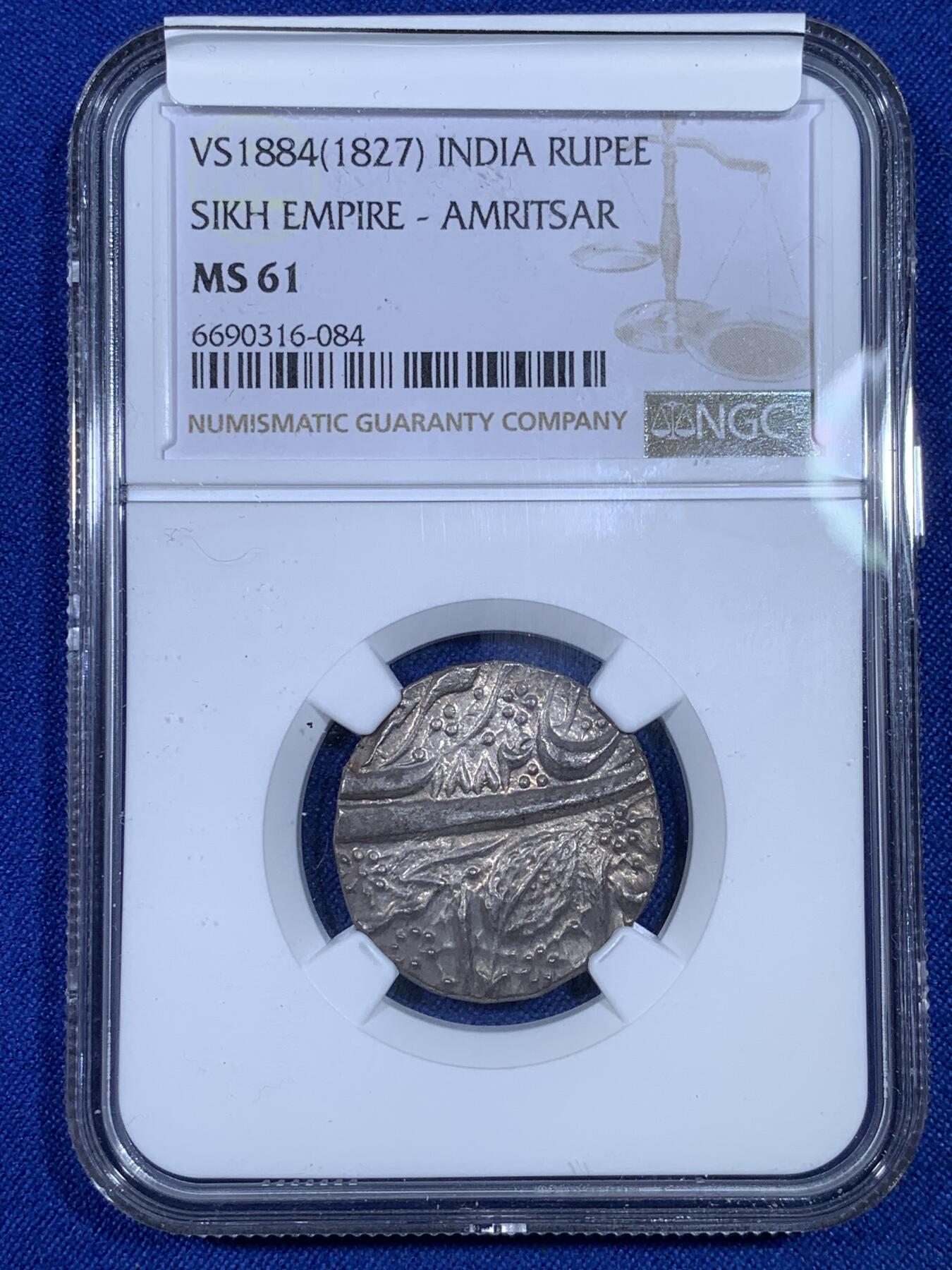 《竞宝斋》第269场- 周日，周一，周二  3场连拍 （全场包邮） NGC MS61 北印度锡克帝国VS1884年（公元1827年）卢比银币 直径约22mm 币重约11克 币文为波斯语 正面为菩提叶和造币地阿姆利则 以及维克拉姆历（V.S.）写就的具体打制年份