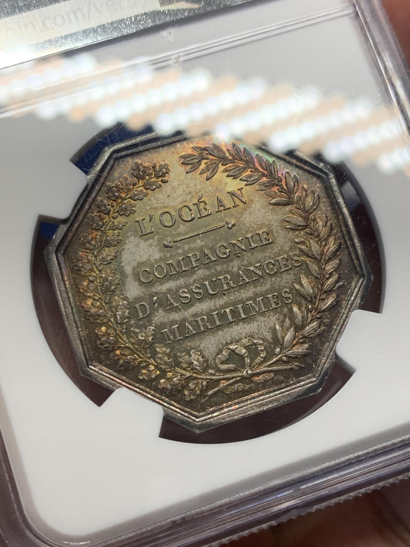 《竞宝斋》第271场-八角与章专场 周日，周一，周二  3场连拍 （全场包邮） NGC-MS62，名誉品海王波塞冬八角银章，必入的法国目录封面币。超级五彩，海神形象充满力量，艺术性高。原铸蜜蜂Bee边铭，比之前上拍的丰饶角边铭更加豪华。这枚和人鱼八角都是八角目录封面，但更加珍稀少见。