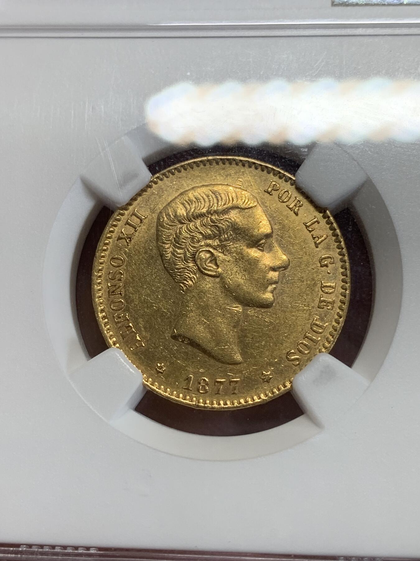 《竞宝斋》第279场- 周日，周一 ，周二3场连拍 （全场包邮） NGC AU58 西班牙 1877年 阿方索十二世25比塞塔金币 8.07克 90%金 金光满溢，铸打深峻，人像肌理真实，状态姣好。阿方索十二世是波旁王朝的西班牙国王（1874年-1885年在位），出生于马德里，是西班牙女王伊丽莎贝二世之子