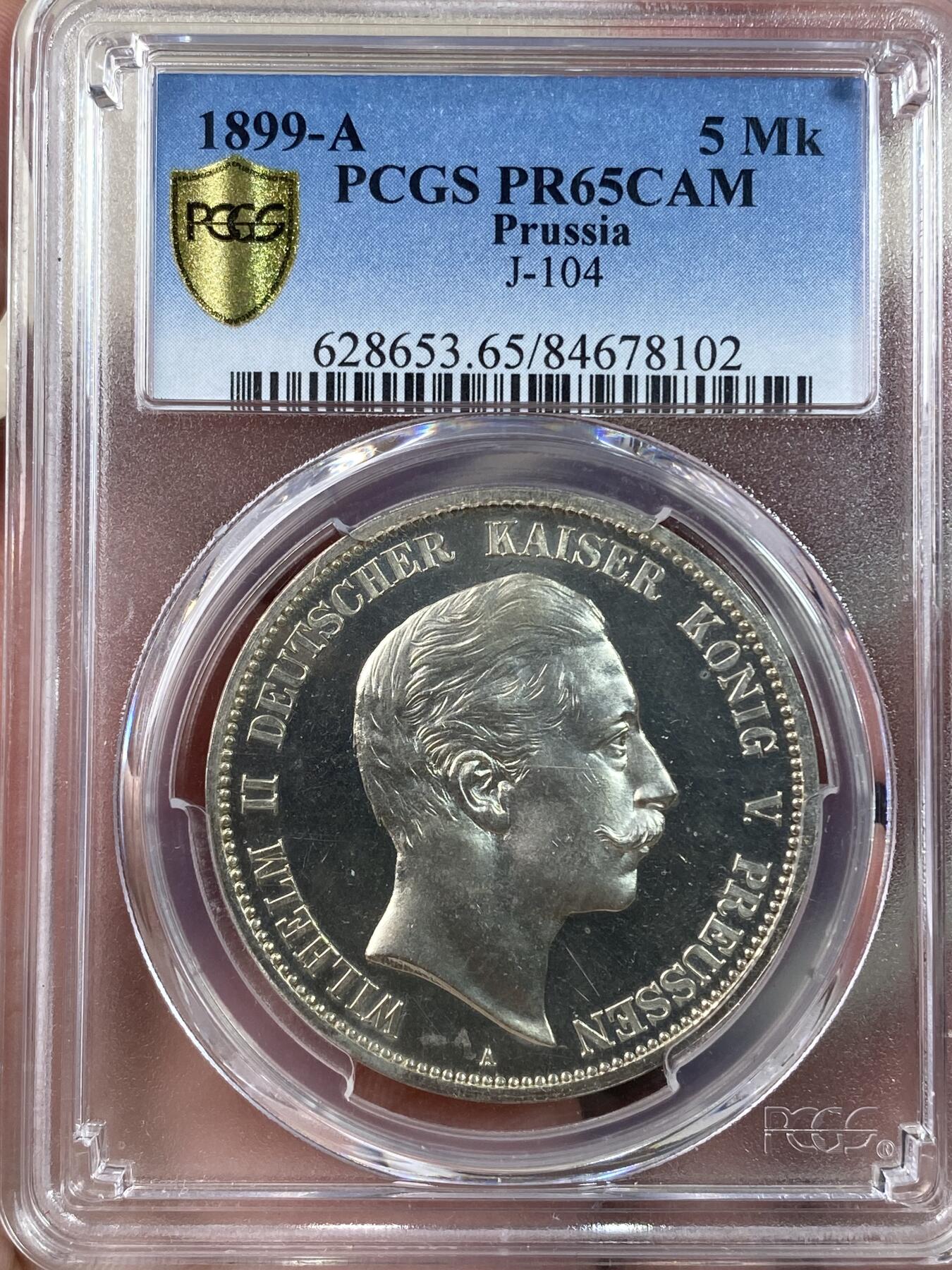 万国钱币拍卖第028期（花前月下●同享良章美币） PCGS PR65CAM 1899年德国威廉二世长翅精制5马克 难度极大的精制年份，底板光洁如镜，和喷砂人像形成鲜明对比，PC唯一精制记录，NGC也仅有两枚且最高分为64，真正难寻其二的藏品。