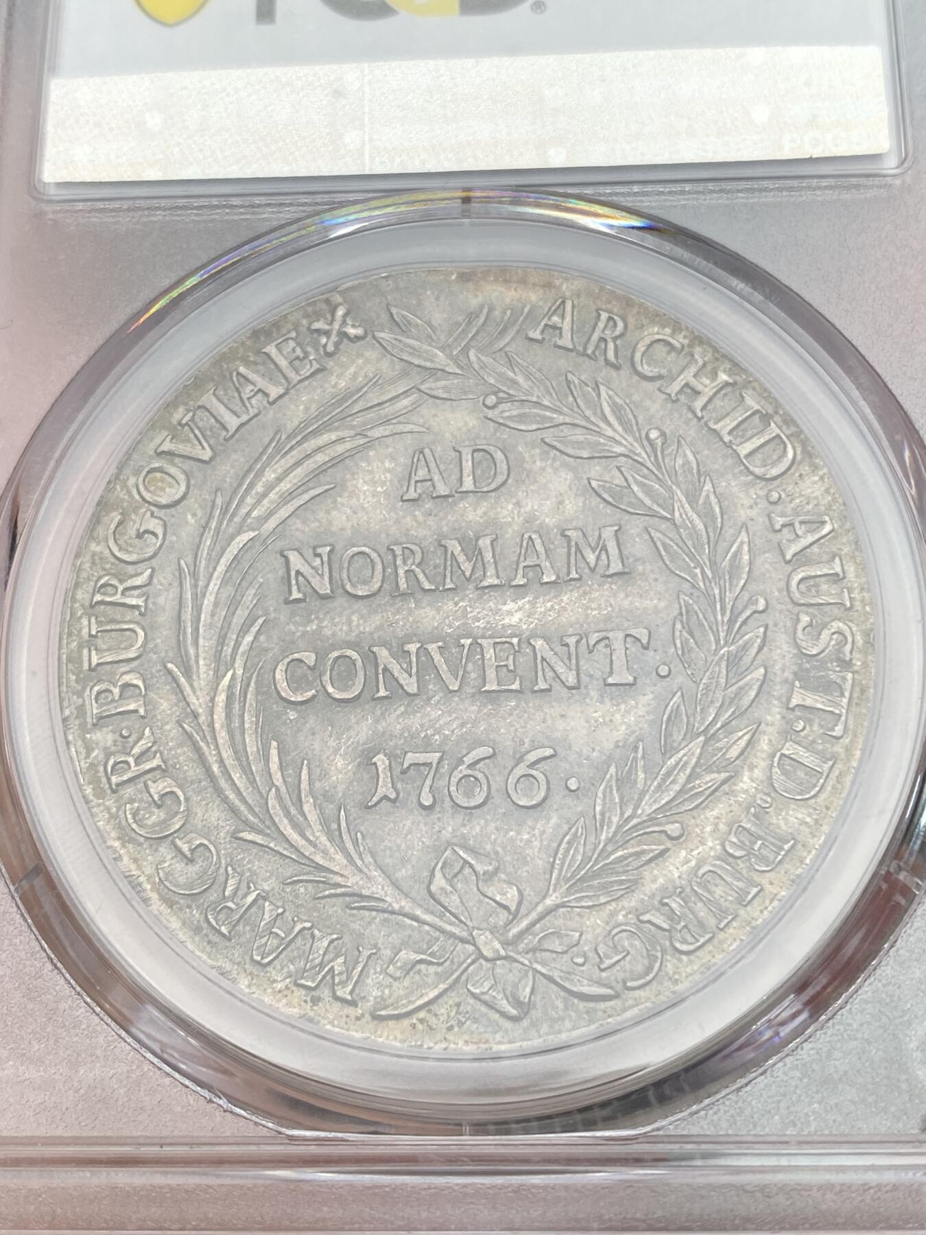 万国钱币拍卖第028期（花前月下●同享良章美币） PCGS MS62 1766年奥地利泰勒 布尔高厂 PCGS MS62  玛丽亚·特蕾莎治下的铸币，正面有其M. THERESIA的皇名，搭配经典的双狮鹫盾徽而非胸像。  两面深打，原始均匀包浆，带有蓝绿色调。