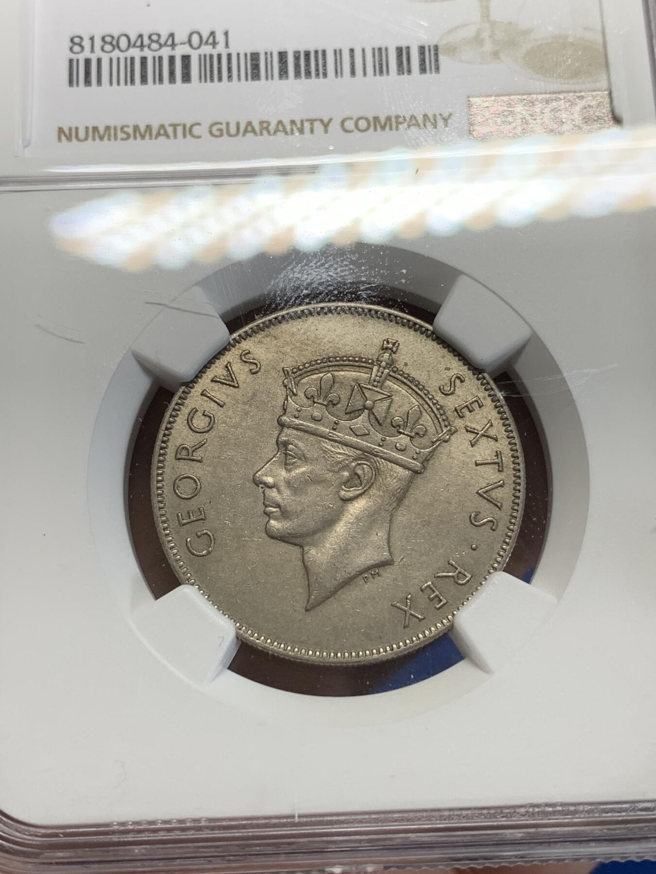 《竞宝斋》第284场- 周日，周一 2场连拍 （全场包邮） NGC MS62 英属东非1952年1先令镍币 很少见的品种 工艺问题 62分已经是很不错的分数了 面值面狮子栩栩如生 细节非常好