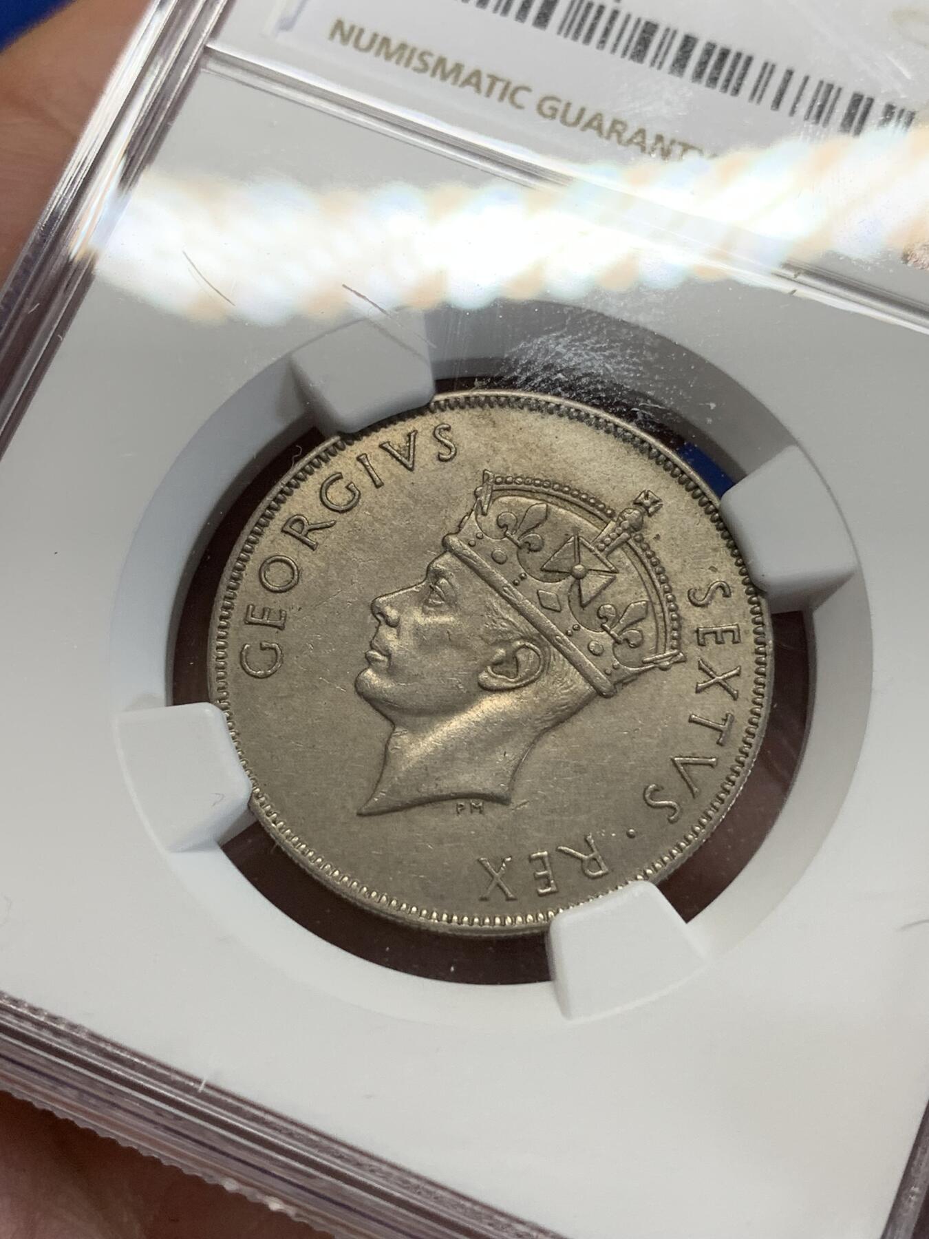 《竞宝斋》第284场- 周日，周一 2场连拍 （全场包邮） NGC MS62 英属东非1952年1先令镍币 很少见的品种 工艺问题 62分已经是很不错的分数了 面值面狮子栩栩如生 细节非常好