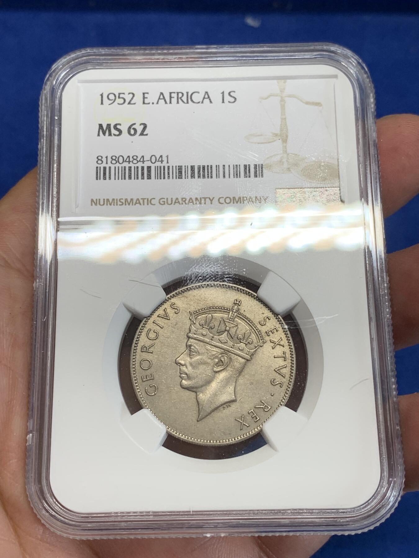 《竞宝斋》第284场- 周日，周一 2场连拍 （全场包邮） NGC MS62 英属东非1952年1先令镍币 很少见的品种 工艺问题 62分已经是很不错的分数了 面值面狮子栩栩如生 细节非常好