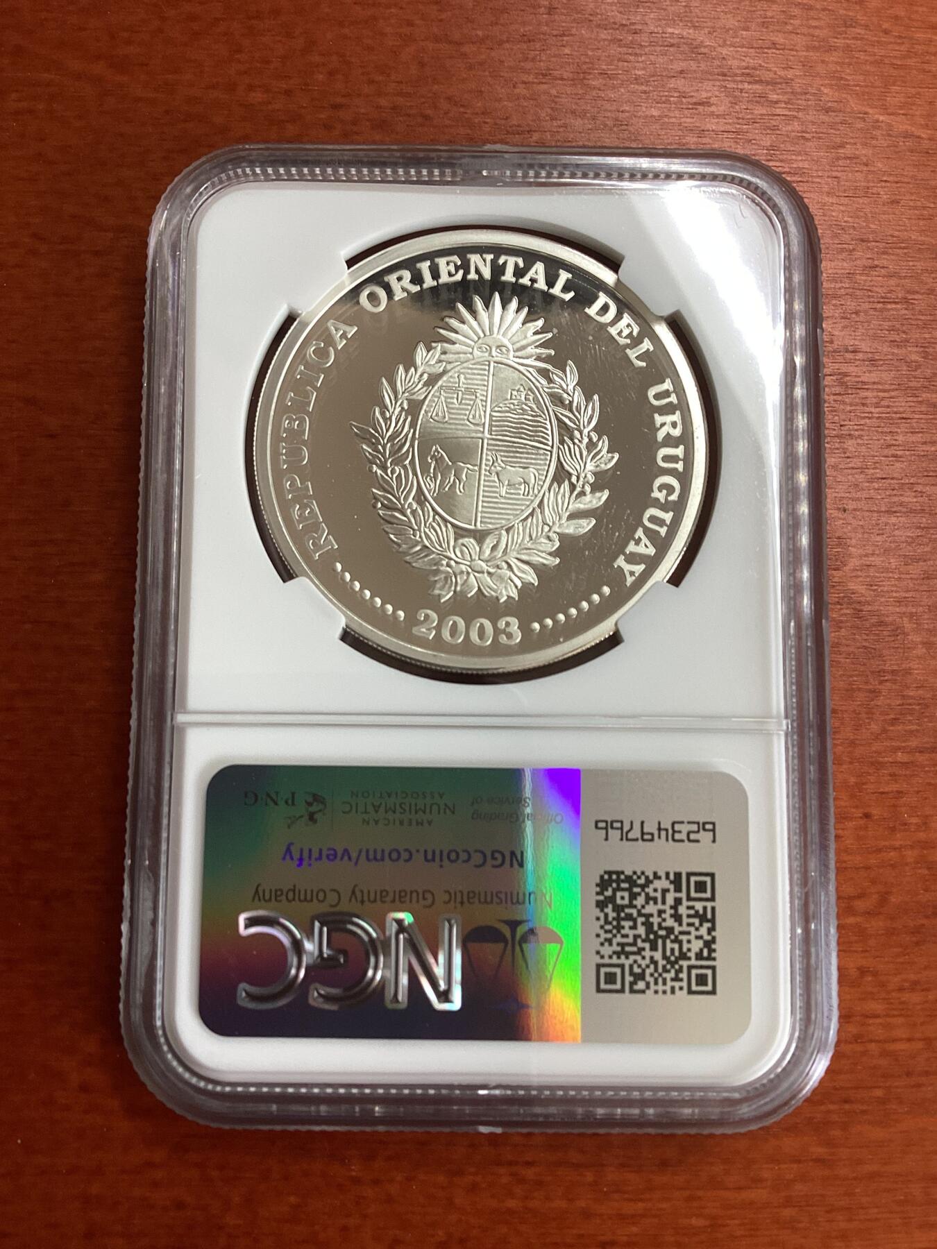 长老汇龙年精选第九场拍卖 2003 乌拉圭2006德国世界杯三枚套币之三踢球1000比索精制银币，NGC PF67UC，唯一季军分，更高分3枚